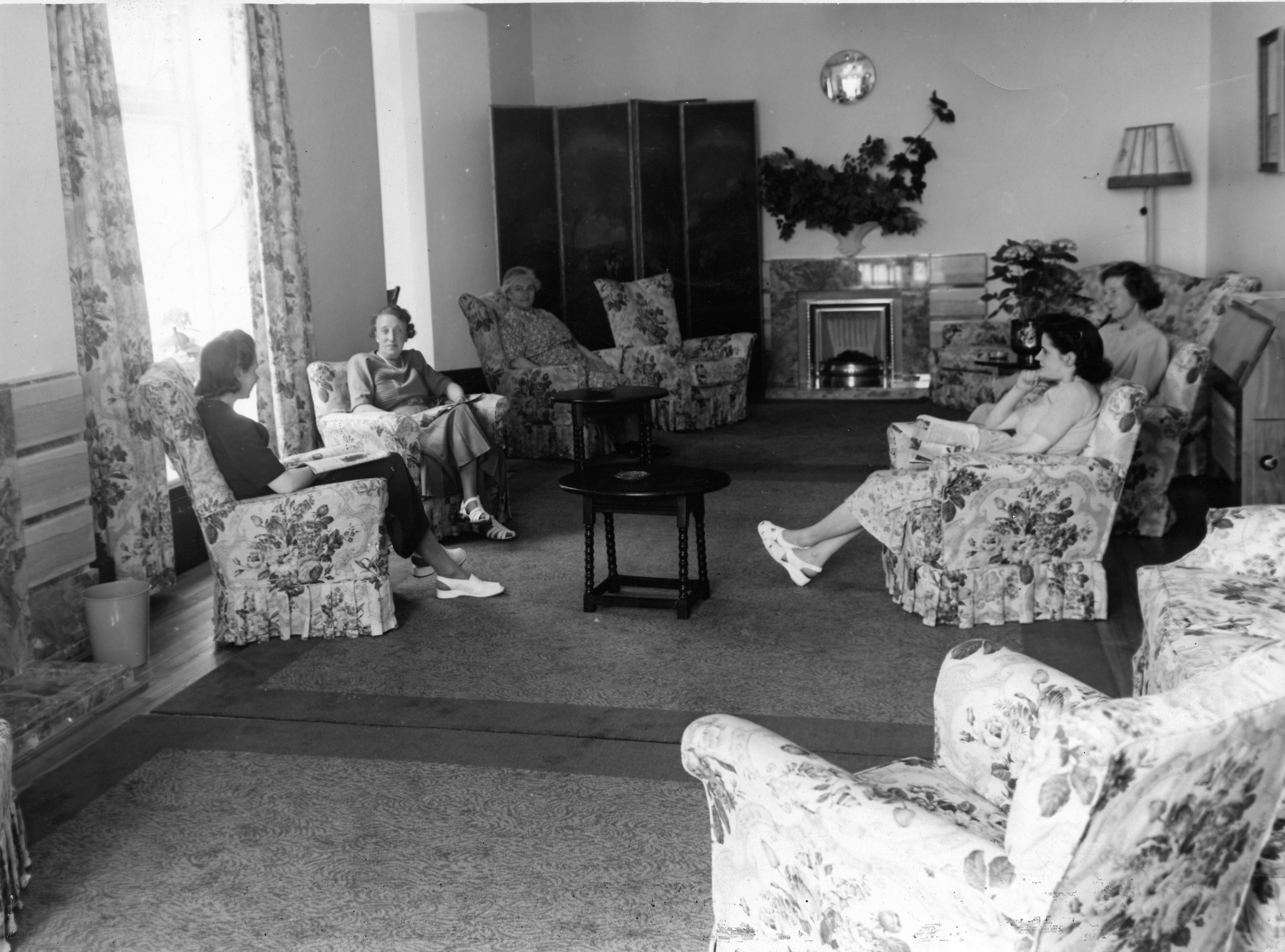 Photograph showing Lucas employees in the sitting room at Inwood House