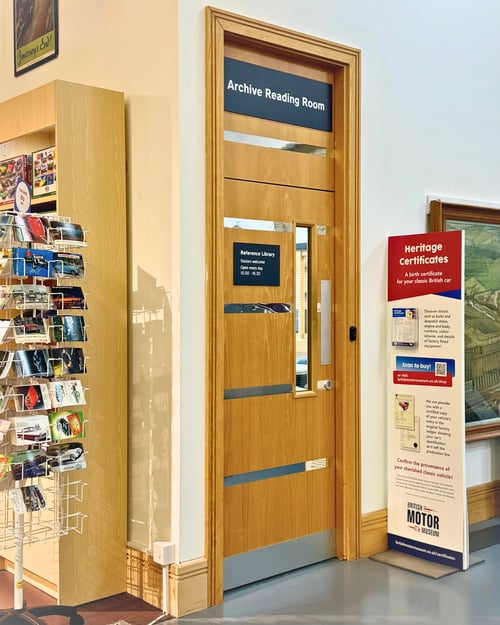 The Archive Reading Room door, a tall door with push to access, located behind the Gift Shop in the Museum.