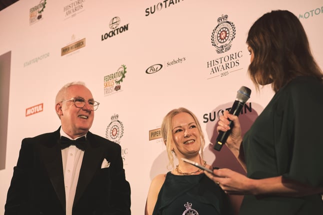 Peter Armstrong, CEO, and Claire Broader, Learning and Engagement Officer, smiling and talking to an interviewer at the awards night.