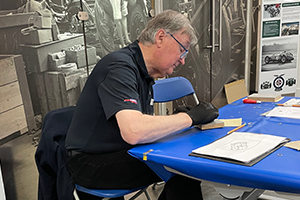 Vounteer Stephen sketching at a table.