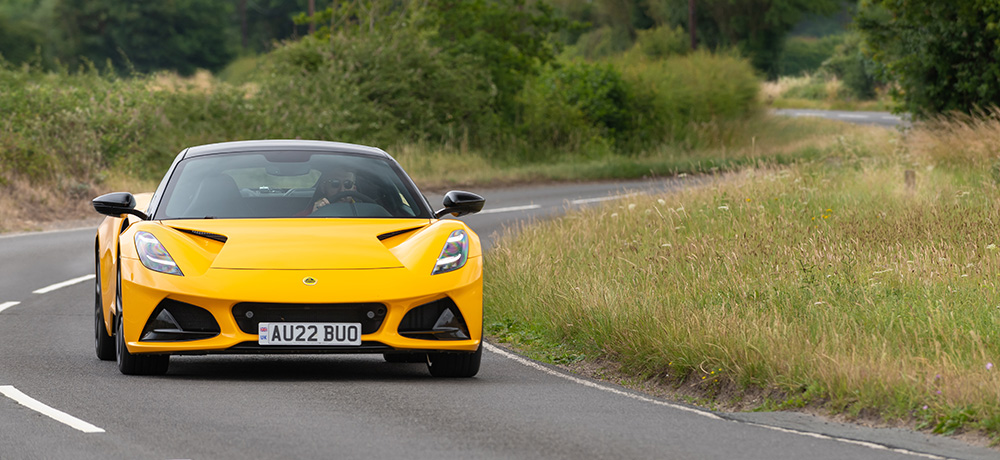 Lotus Emira driving at speed on a country road