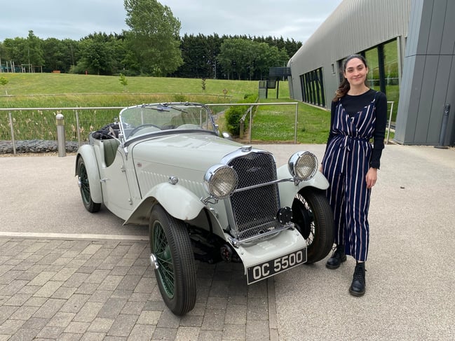 Museum Curator Cat Boxhall standing next to the the Singer Le mans