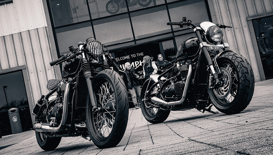 Two Triumph Motorcycles outside a company building