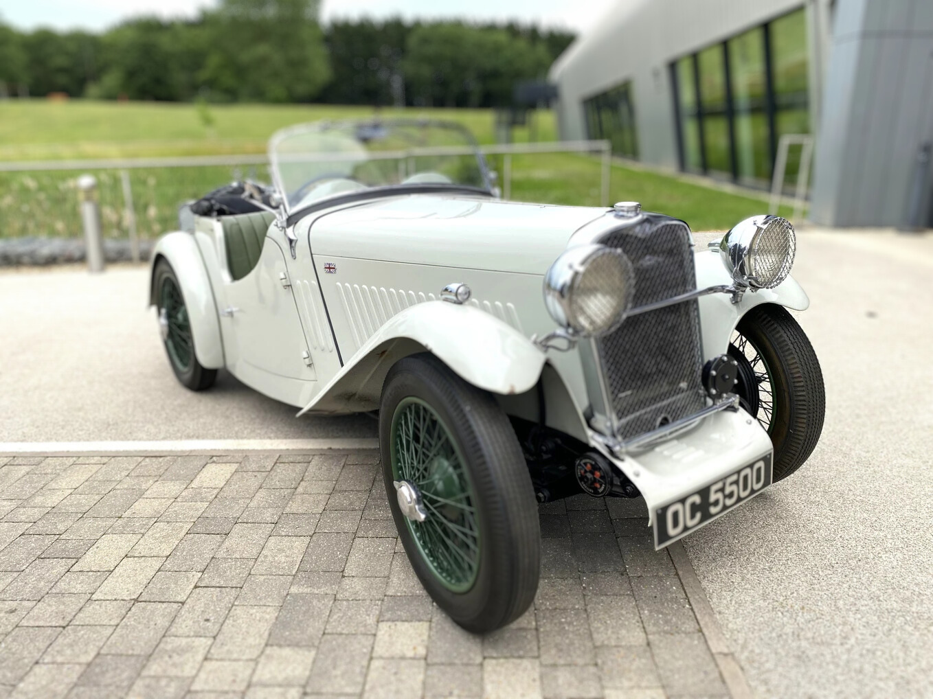 A photo of the first 71 Singer 1 ½ litre Le Mans car outside the front of the Collections Centre with grass and trees in the background