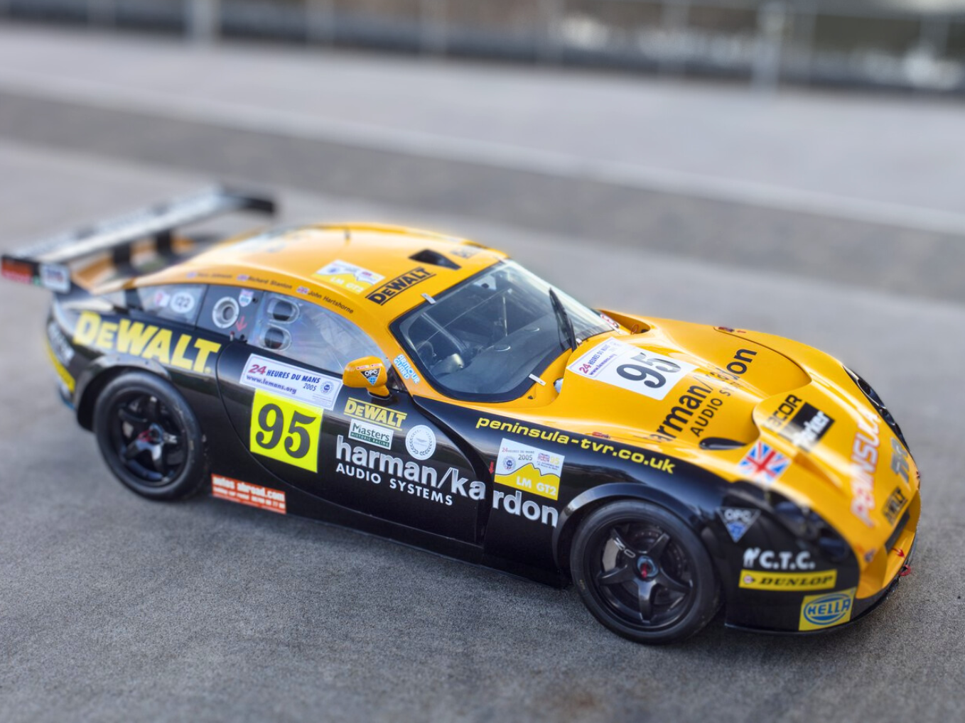 A photo of the side of the black and yellow TVR T400 outside the front of the Collections Centre at the Museum.