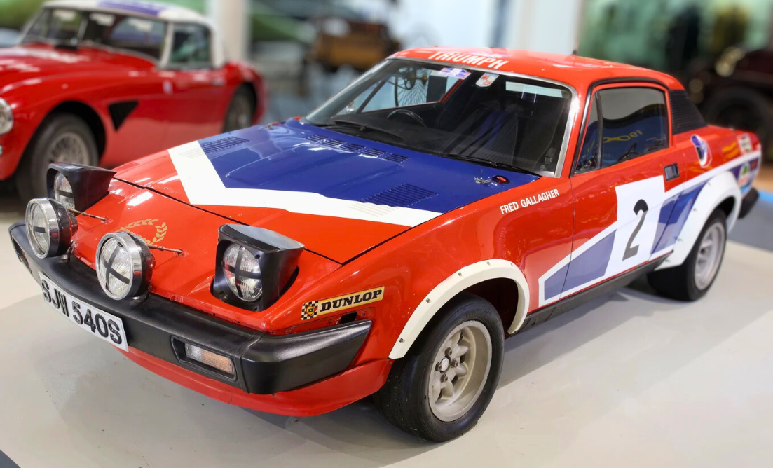 Photo of the red white and blue 1978 Triumph TR7 in the Museum
