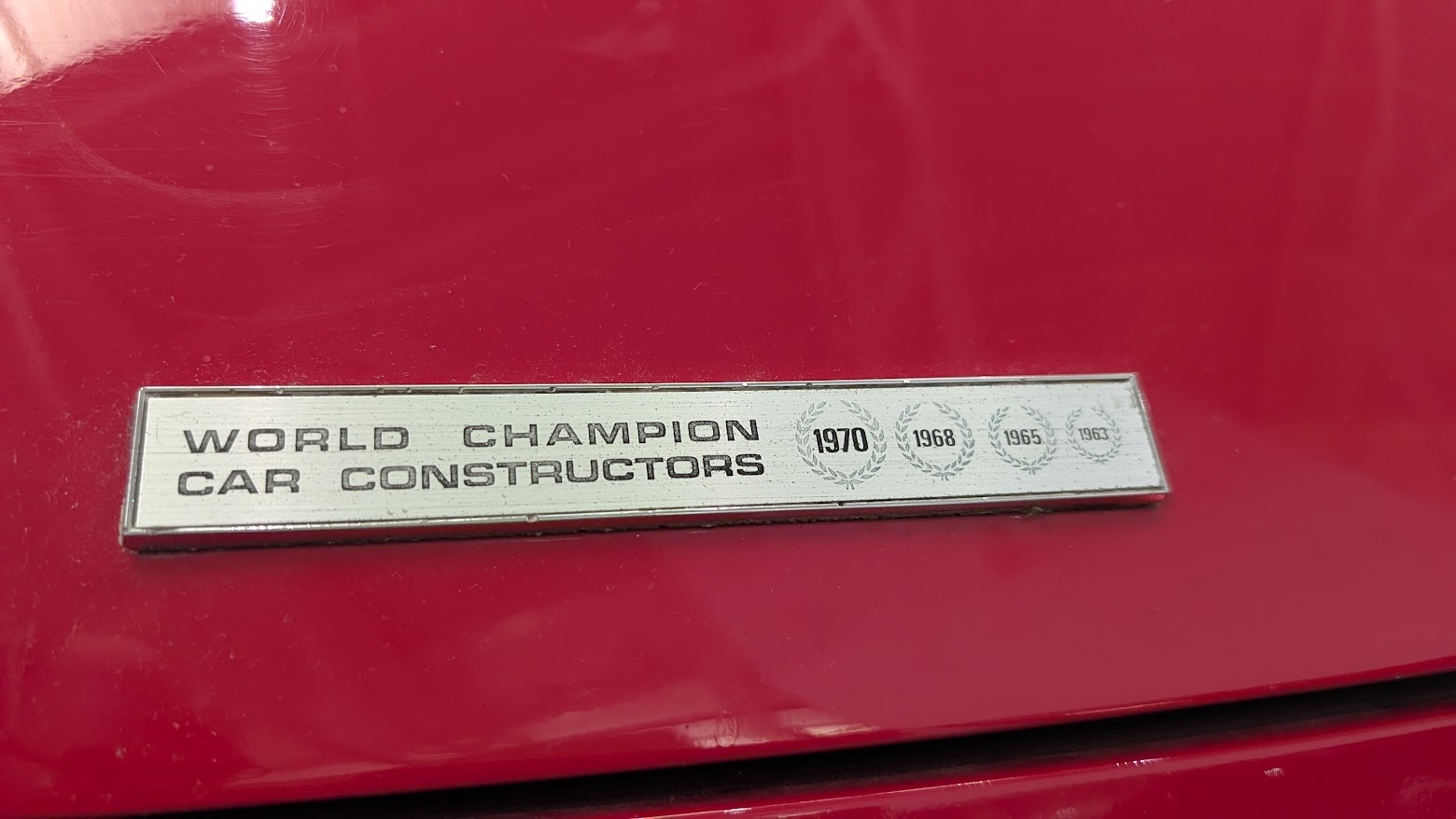 A badge that says 'World Champion Car Constructors'